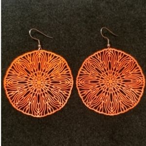 Orange, metal lace, light earrings.